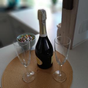 eine Flasche Wein und zwei Gläser auf dem Tisch in der Unterkunft Apartament Hetmańska in Wałbrzych