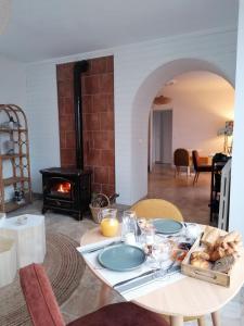 a table with a plate of food and a fireplace at La Bulle d'Etel, Chambres & Spa in Étel