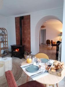 a table with a plate of food and a fireplace at La bulle d'Etel, chambres & spa in Étel