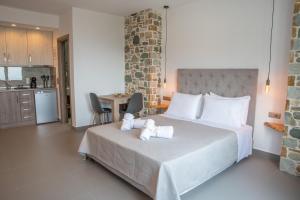 a bedroom with a bed with two towels on it at Aelia Mount Suites in Zagora