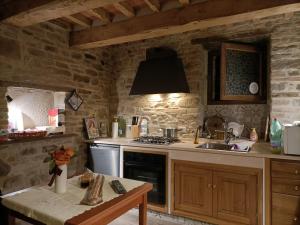 a kitchen with a sink and a stove top oven at La Terrazza camere Sansepolcro in Sansepolcro