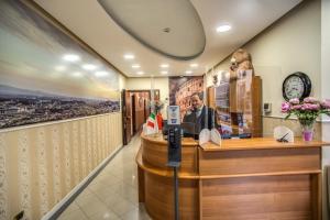 a cashier counter in a restaurant with a picture on the wall at Hotel Ottaviano Augusto in Rome