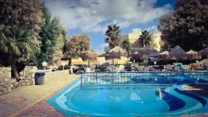 a swimming pool at a hotel with a resort at Cozy Home (close to the beach) in Agia Marina Nea Kydonias