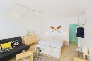 a bedroom with a bed and a couch at Vlnka Apartments in Piešťany +47 photos