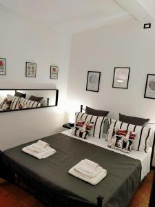 a bedroom with a bed with two towels on it at La Tegola in Tivoli