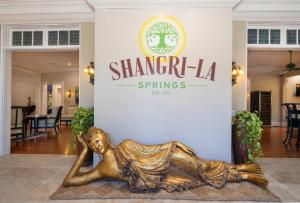 a statue of a woman laying on the floor in a lobby at Shangri-La Springs in Bonita Springs