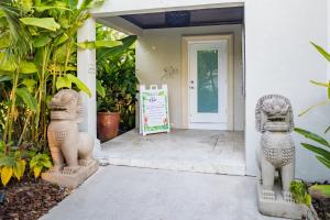 two stone lions standing outside of a building at Shangri-La Springs in Bonita Springs