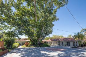 a large tree in front of a house at Shangri-La Springs in Bonita Springs