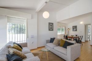 a living room with two couches and a table at Casa en Villa Carlos Paz con Pileta , Quincho y Jardín a Pasos del Centro in Villa Carlos Paz