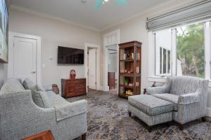 a living room with two couches and a tv at Shangri-La Springs in Bonita Springs