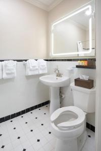 a bathroom with a white toilet and a sink at Shangri-La Springs in Bonita Springs