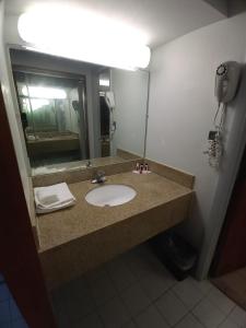 a bathroom with a sink and a mirror at Travelodge by Wyndham Petersburg in Petersburg