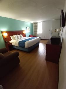 a hotel room with a bed and a television at Travelodge by Wyndham Petersburg in Petersburg