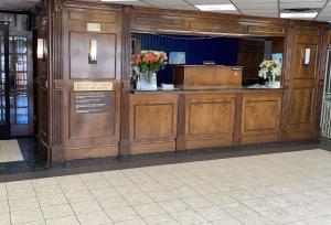 a lobby with a cash counter in a building at Travelodge by Wyndham Petersburg in Petersburg