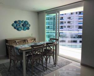a dining room with a table and chairs and a window at Apartamento Duplex en Santa Marta, Pozos Colorados in Santa Marta +13 photos
