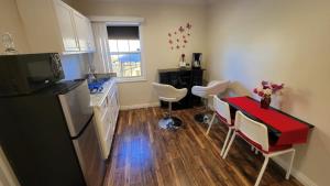 a kitchen with a red table and a counter top at Adorable modern guesthouse with full kitchen in Encino