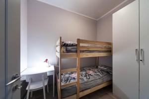 a bedroom with two bunk beds and a desk at B&B Portorosso in Monopoli