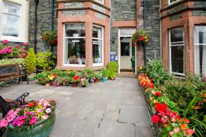 un edificio con dei fiori davanti di Abacourt House a Keswick