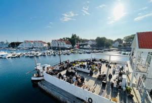 a group of people sitting on a boat in the water at Hummeren Hotel in Tananger