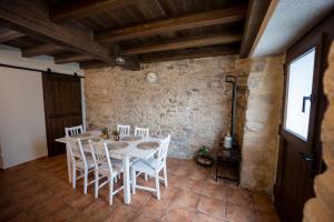 a dining room with a white table and chairs at A de Pepita, turismo rural en Padrón. in Padrón