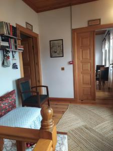 a living room with a door and chairs and a table at Katina Boutique Otel in Sirince