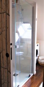 a glass cabinet with shelves in a room at Maison de contes en amoureux in Taden +21 photos