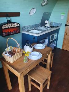 a kitchen with a table with a basket of food at Ty Cnocell in Boncath