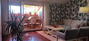 a living room with a couch and a table at Atico C&E Cambados in Cambados