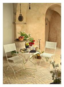 ウルビーノにあるSanpolo 1544 Antique Roomのテーブルと椅子付きの部屋で、椅子2脚とテーブル1台が備わります。