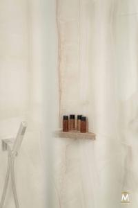 Un baño con cortina de ducha y un estante con cosméticos. en Museum Center Luxury, en Reggio Calabria