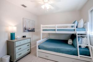 una camera da letto con un letto a castello e una scrivania di Beachside snowbird escape with fenced yard & washer/dryer - walk to beach access a Baptist Medical Center/Beaches Heliport