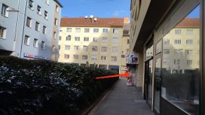 an orange arrow is pointing towards a building at Vintage Apartment in Graz