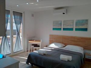 a bedroom with a bed with two towels on it at suite room malpensa b&b in Cardano al Campo +23 photos