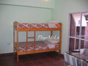 a bunk bed in a room with a window at Playa MaLú in Las Toninas