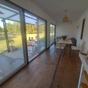 a living room with sliding glass doors and a table at La irupe in Capilla del Señor