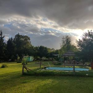 a swimming pool in a yard with a gazebo at La irupe in Capilla del Señor