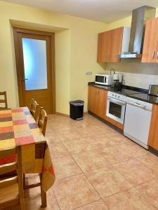 a kitchen with a table and a table and chairs at Apartment Lecer 7 - 2nd floor in Porta