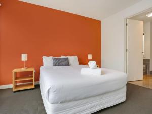 A bed or beds in a room at The White House Merimbula