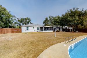a house with a swimming pool in a yard at Navarre Hideaway in Navarre