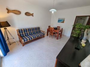 a living room with a couch and a table at Apartamento Praia Altura by Homekeys in Altura