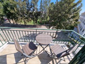 two chairs and a table on a balcony at Apartamento Praia Altura by Homekeys in Altura