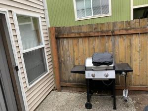 a barbecue grill sitting outside of a house at Cozy 2 Bedroom Townhouse in Northgate in Seattle