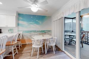 a kitchen and dining room with a table and chairs at Our Place at the Beach I-101 in Ocean City