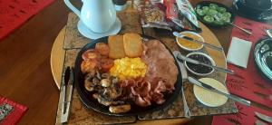 a plate of breakfast food on a table at Koutu Beach Bed and Breakfast in Rotorua
