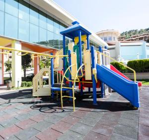 a playground with a slide in front of a building at Eliz Hotel Convention Center Thermal Spa & Wellnes in Ankara