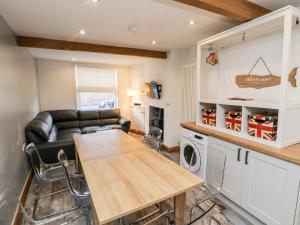 a kitchen and living room with a couch and a table at 11A Church Street in Whitby
