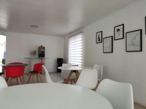 a room with a bed and chairs and a table at Hostal Doñihue in Doñihue