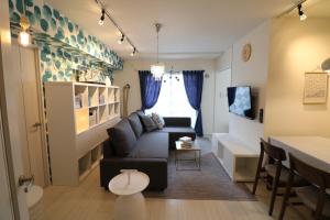 a living room with a couch and a table at Hassamu 3 Jo 1-11-1 Corole Kotoni - Vacation STAY 11468 in Sapporo