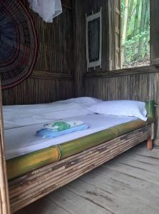 a bed in a wooden room with a mattress at Mama Gia Homestay in Sa Pa