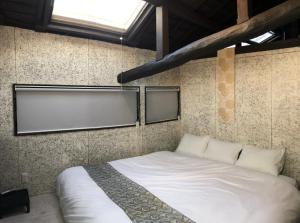 a bedroom with a white bed with two windows at KOU Nishijin - Vacation STAY 36633v in Kyoto
